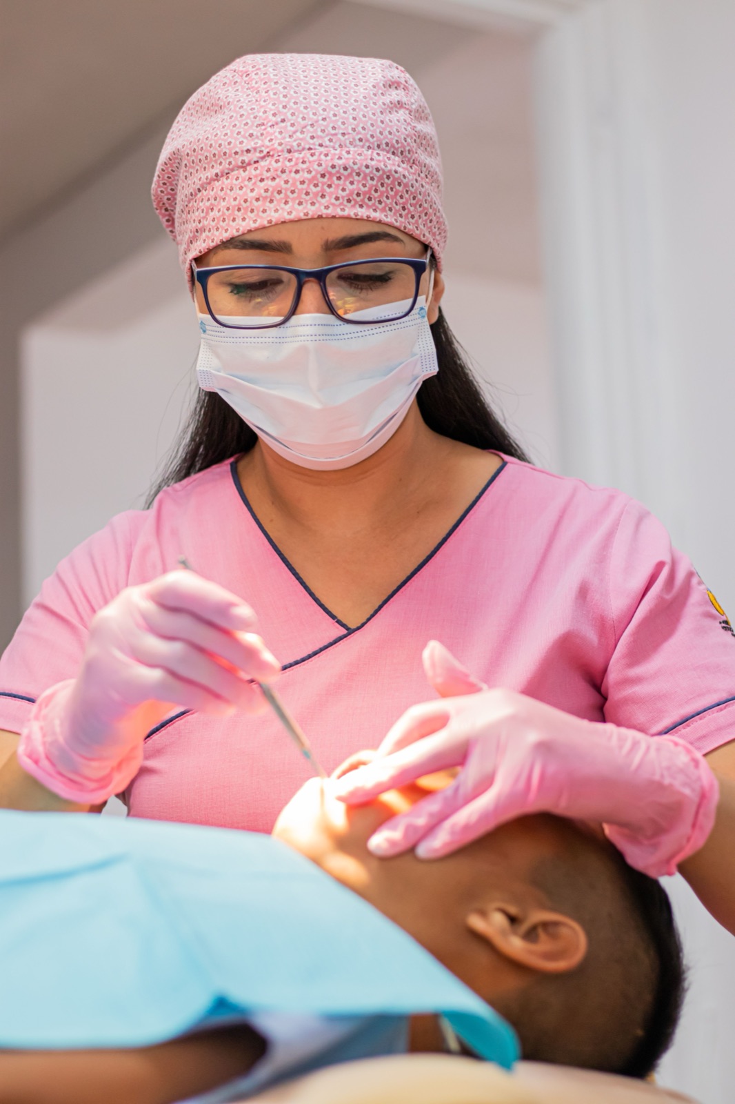 Dentist examining a patient's teeth at Zoe Premium Dental
